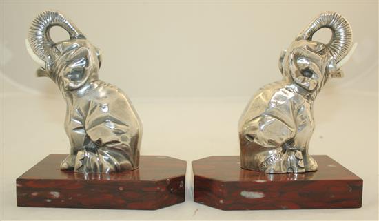 A pair of French Art Deco silvered metal and red marble elephant bookends, 5.5in.